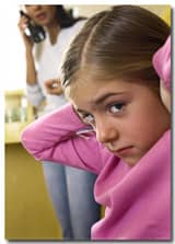 girl holds her ears during divorced parents' telephone conversation